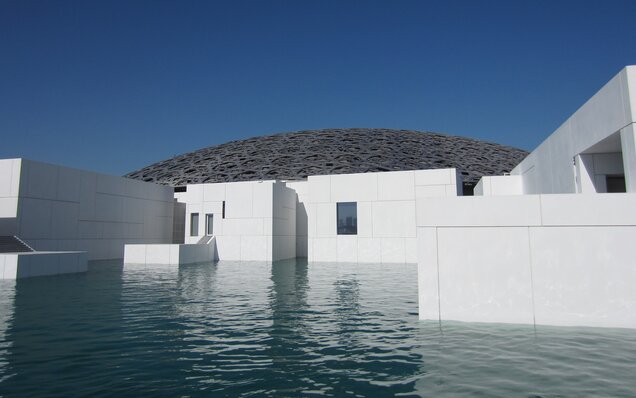 Modern Louvre Abu Dhabi with water basin