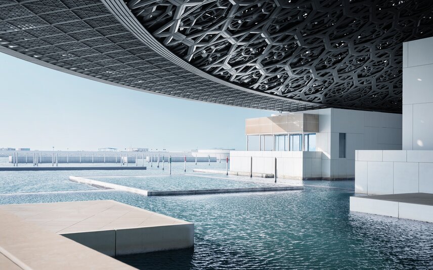 Modern structure with water and lattice roof