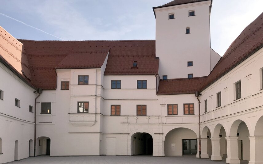 Courtyard with arcades and white facade