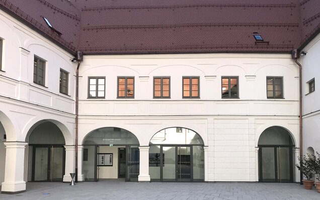 Courtyard with arcades and red roof tiles
