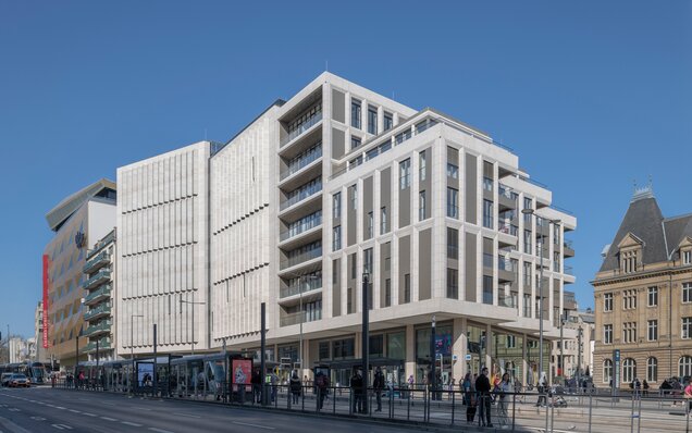 Modern building with tram and people