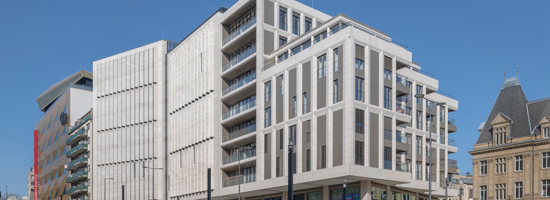 Modern building with tram and people