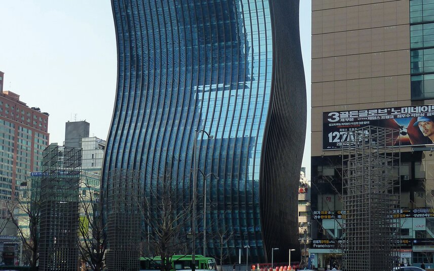 Modern glass building with undulating facade