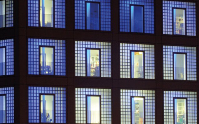 Illuminated glass facade of modern offices